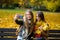 Mellow autumn. Two cute students makes a selfie in the park.