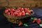 Mellow strawberries in rattan basket on tablecloth