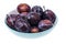 Mellow sweet plum in plate on white background