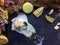 Melt white icecream with lemon on a black tray