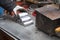 Melted alloy bars stacked in a pyramid on a workbench.