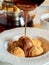 Melted chocolate pours onto profiteroles