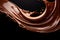 Melted chocolate splash, tasty chocolate wave floating in mid air isolated on dark background, close up shot, food background.