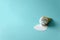 Melted paper vanilla ice-cream cone on blue background. Copy space. Creative or art food concept