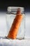 Melted snowman in winter waiting for the new winter season in the jar as a fresh carrot