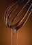 Melting chocolate dripping from whisk