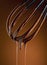 Melting chocolate dripping from whisk