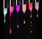 Melting colored lipsticks with falling drops down on black