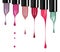 Melting colored lipsticks with falling drops down on white