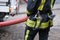 A member of the fire brigade holds a water supply hose
