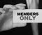 MEMBERS ONLY on a card Businessman holds. VIP clients in business concept