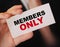 MEMBERS ONLY on a card Businessman holds. VIP clients in business concept