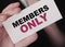 MEMBERS ONLY on a card Businessman holds. VIP clients in business concept