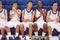 Members Of Male High School Basketball Team Watching Match