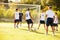 Members Of Male High School Soccer Playing Match