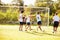 Members Of Male High School Soccer Playing Match