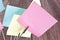 Memo holder with colorful sticky notes on wooden background