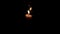 Memorial candle burning on a black background.