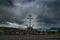 Memorial cross in Greenock against a cloudy sky with the town in the background on a gloomy day