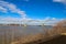 The Memphisâ€“Arkansas Memorial Bridge over the vast flowing waters of the Mississippi river with powerful clouds and blue sky