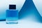 Men aftershave on blue background with copy space