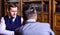 Men with antique bookshelves on background. Intelligent men