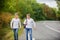 Men backpack walking road. Twins walk along road. Brothers friends nature background. Long way. Adventure concept. Guys