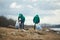 Men with bags collecting garbage