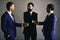 Men with beard and happy faces discuss business plans shaking hands. Businessmen wear smart suits and ties. Executives