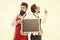 Men bearded bartender in apron hold blank chalkboard. Bartender with blackboard advertisement. Hipster bartender show
