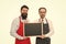 Men bearded bartender or cook in apron hold blank chalkboard. Bartender with blackboard. Hipster bartender show