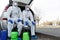Men in biohazard suits sitting in car with disinfection chemicals