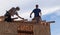 Men build roof for home for Habitat For Humanity