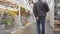 Men with a cart and basket pass along the shelves with goods in a large supermarket of construction materials