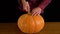 Men Carve Jack O` Lantern pumpkin for Halloween Celebration