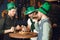 Men celebrate St. Patrick& x27;s Day at bar with a mug of beer