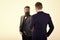 Men in classic suits, businessmen, business partners meeting, white background, isolated. Businessmen shaking hands