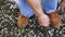 Men commits an outdoor walk and stopped to tie his shoelaces on sneakers.