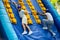 Men competing in climbing on inflatable slide