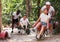 Men drive their girls in garden wheelbarrows. Funny amusement park amusement park