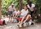 Men drive their girls in garden wheelbarrows. Funny amusement park amusement park