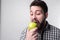 Men eats an apple. bearded guy holding an apple. vegetarian preparing dinner