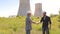 Men engineers shaking hands at construction site.