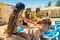 Men enjoy a massage from women near the swimming pool