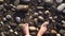 Men feet on the shore of a rocky beach by the sea top view