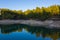 Men fishing in a natural peaceful lake by pine trees