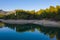 Men fishing in a natural peaceful lake by pine trees