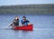 Men Fishing for Small Mouth Bass from a Red Canoe in late September.