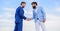 Men formal suits shaking hands blue sky background. Business deal approved accepted by both partners. Entrepreneurs