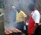 Men grilling hot dogs and hamburgers